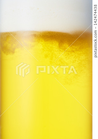 Close-up of draft beer poured into a mug. Close-up of draft beer poured into a mug. 142474438