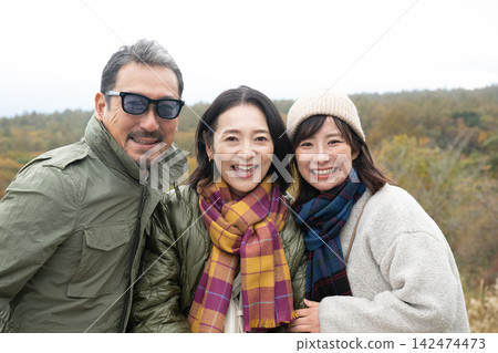Three friends smiling in a field of pampas grass on a plateau. Three friends smiling in a field of pampas grass on a plateau. 142474473