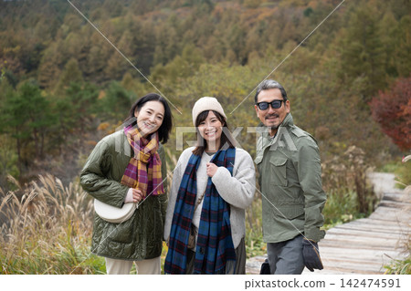 Three people enjoying the view overlooking the Yatsugatake Mountains Three people enjoying the view overlooking the Yatsugatake Mountains 142474591