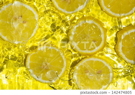 Fresh citrus lemon slices splashing in bright water background. Fresh citrus lemon slices splashing in bright water background. 142474805