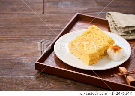 Japanese-style egg dish: Rolled omelet with dashi broth, served with grated daikon radish. Japanese-style egg dish: Rolled omelet with dashi broth, served with grated daikon radish. 142475147
