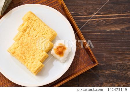 Japanese-style egg dish: Rolled omelet with dashi broth, served with grated daikon radish. Japanese-style egg dish: Rolled omelet with dashi broth, served with grated daikon radish. 142475149