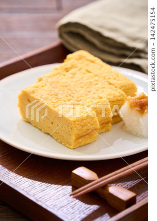 Japanese-style egg dish: Rolled omelet with dashi broth, served with grated daikon radish. Japanese-style egg dish: Rolled omelet with dashi broth, served with grated daikon radish. 142475154