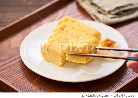 Japanese-style egg dish: Rolled omelet with dashi broth, served with grated daikon radish. Japanese-style egg dish: Rolled omelet with dashi broth, served with grated daikon radish. 142475156