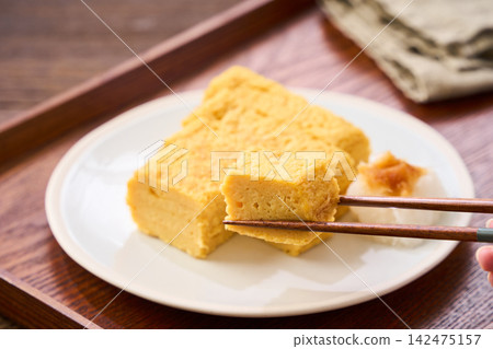 Japanese-style egg dish: Rolled omelet with dashi broth, served with grated daikon radish. Japanese-style egg dish: Rolled omelet with dashi broth, served with grated daikon radish. 142475157
