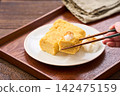 Japanese-style egg dish: Rolled omelet with dashi broth, served with grated daikon radish. Japanese-style egg dish: Rolled omelet with dashi broth, served with grated daikon radish. 142475159