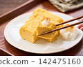 Japanese-style egg dish: Rolled omelet with dashi broth, served with grated daikon radish. Japanese-style egg dish: Rolled omelet with dashi broth, served with grated daikon radish. 142475160