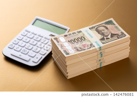 A stack of 6 million yen bills and a calculator A stack of 6 million yen bills and a calculator 142476081