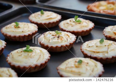 Golden Baked Egg and Cheese Tarts Arranged in a Bakery Box Golden Baked Egg and Cheese Tarts Arranged in a Bakery Box 142476216