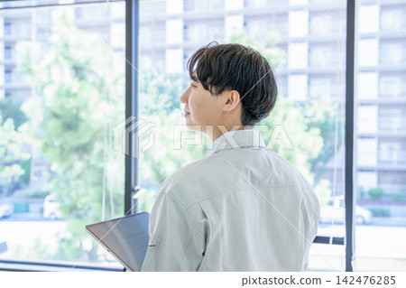 A young man working on clothes A young man working on clothes 142476285