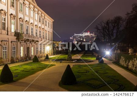 Scenic night view of the illuminated Mirabell Palace and gardens with the Hohensalzburg Fortress in the background, Salzburg, Austria Scenic night view of the illuminated Mirabell Palace and gardens with the Hohensalzburg Fortress in the background, Salzburg, Austria 142476617