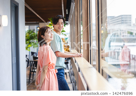 一對男女一邊欣賞風景，一邊平靜地交談。 142476896