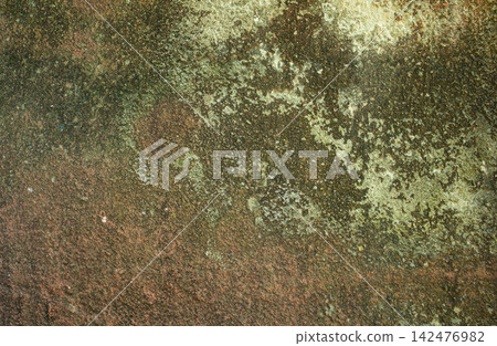 Close up view of a weathered stone surface with moss and grunge in an outdoor setting 142476982