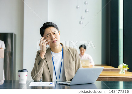 An agonizing businessman An agonizing businessman 142477216