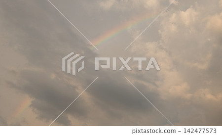 A rainbow that appeared in the sky after rain A rainbow that appeared in the sky after rain 142477573
