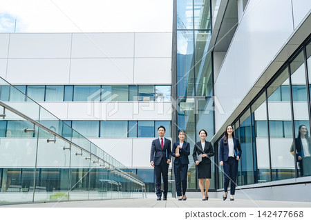 A group of business people walking down the street. Teamwork, colleagues, progress, advancement, start, goal, challenge. A group of business people walking down the street. Teamwork, colleagues, progress, advancement, start, goal, challenge. 142477668