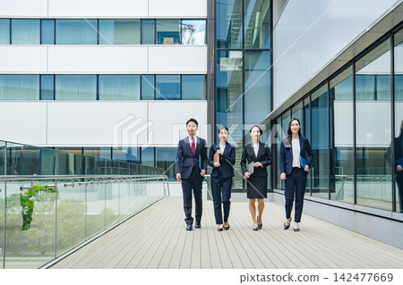 A group of business people walking down the street. Teamwork, colleagues, progress, advancement, start, goal, challenge. A group of business people walking down the street. Teamwork, colleagues, progress, advancement, start, goal, challenge. 142477669