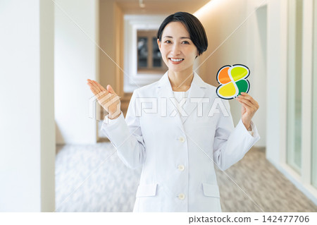 A woman in a white coat with a senior citizen symbol. Doctor, hospital, caregiving, welfare, elderly, senior, silver, support, assistance A woman in a white coat with a senior citizen symbol. Doctor, hospital, caregiving, welfare, elderly, senior, silver, support, assistance 142477706