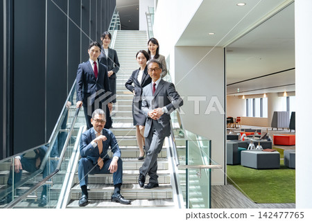 A group of business professionals, both male and female, from a wide range of generations. Teamwork, cooperation, human resources, management, CEO, executives. A group of business professionals, both male and female, from a wide range of generations. Teamwork, cooperation, human resources, management, CEO, executives. 142477765