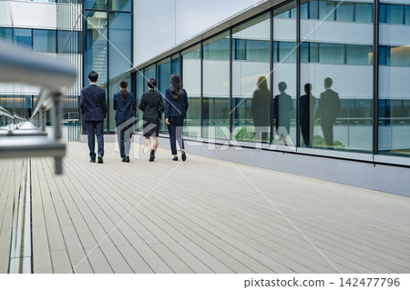 A group of business people walking down the street. Teamwork, colleagues, progress, advancement, start, goal, challenge. A group of business people walking down the street. Teamwork, colleagues, progress, advancement, start, goal, challenge. 142477796