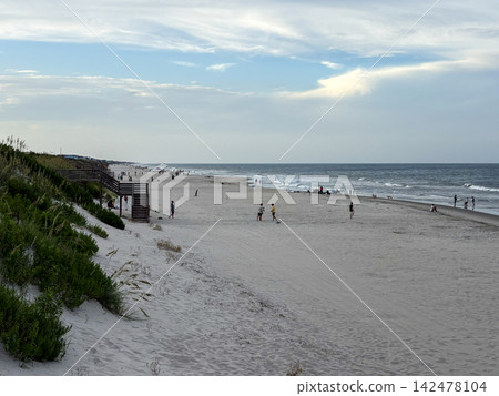 People Walk and Play on the Beach in Corolla North Carolina People Walk and Play on the Beach in Corolla North Carolina 142478104