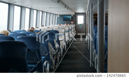 Passengers on seats inside the sea vessel Meteor Passengers on seats inside the sea vessel Meteor 142478665
