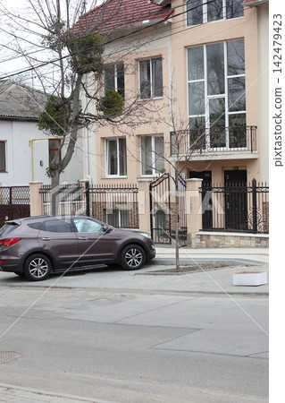 Front of a modern building on a quiet street in a residential area 142479423