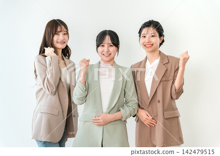 Three young Asian businesswomen smile and give a thumbs-up. Three young Asian businesswomen smile and give a thumbs-up. 142479515