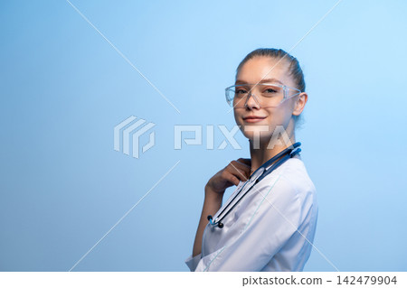 Young female doctor wearing safety glasses and stethoscope Young female doctor wearing safety glasses and stethoscope 142479904