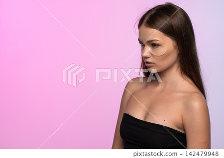 Young woman applying under eye patches for hydration, reducing dark circles, and anti-aging skincare routine Young woman applying under eye patches for hydration, reducing dark circles, and anti-aging skincare routine 142479948