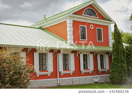 Historic Red Brick Building with White Trim and Triangular Gable Historic Red Brick Building with White Trim and Triangular Gable 142480236