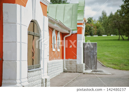 Ornate Red and White Architectural Entrance with Arched Doorway 142480237