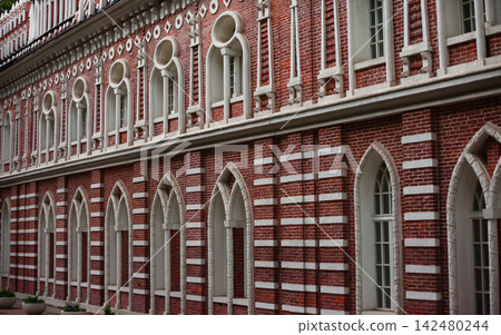 Detailed Red Brick Historic Facade with White Decorative Trim Detailed Red Brick Historic Facade with White Decorative Trim 142480244