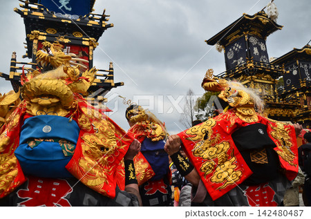 Inuyama Festival in Aichi Prefecture, Japan: Floats carrying mechanical puppets; children in gold-colored dragon costumes being carried on the shoulders of adults. Inuyama Festival in Aichi Prefecture, Japan: Floats carrying mechanical puppets; children in gold-colored dragon costumes being carried on the shoulders of adults. 142480487