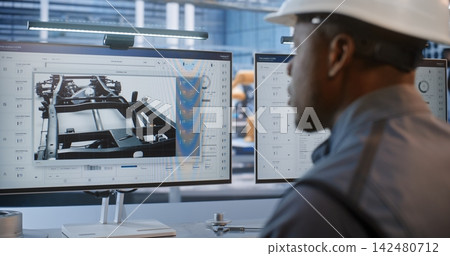 Technician Programming Automated Assembly Lines in Plant Technician Programming Automated Assembly Lines in Plant 142480712
