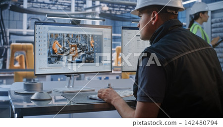 Engineer Monitoring 3D Chassis Design and Data on Screen in Smart Car Factory Engineer Monitoring 3D Chassis Design and Data on Screen in Smart Car Factory 142480794