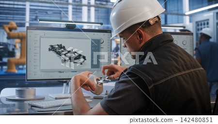 Engineer Measuring Metal Prototype with Caliper in Front of 3D CAD Screen Engineer Measuring Metal Prototype with Caliper in Front of 3D CAD Screen 142480851