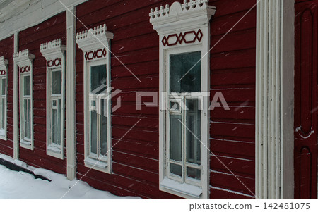 Red Historic Building Facade with White Decorative Windows 142481075
