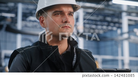 Technician Auditing Automated Production Line via Mobile Tablet Technician Auditing Automated Production Line via Mobile Tablet 142481085
