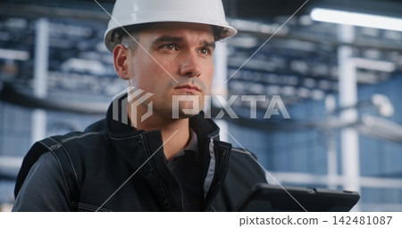Technician Auditing Automated Production Line via Mobile Tablet Technician Auditing Automated Production Line via Mobile Tablet 142481087