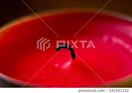 Red Candle Wax Surface with Black Wick Red Candle Wax Surface with Black Wick 142481282