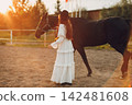 Woman with her horse at outdoors ranch 142481608