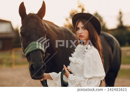 Woman with her horse at outdoors ranch Woman with her horse at outdoors ranch 142481621
