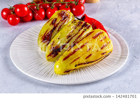 Grilled yellow bell peppers with fresh cherry tomatoes on a white plate Grilled yellow bell peppers with fresh cherry tomatoes on a white plate 142481701