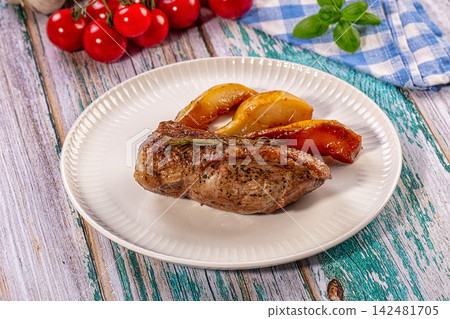 Roasted duck breast with caramelized pears and rosemary on white plate Roasted duck breast with caramelized pears and rosemary on white plate 142481705