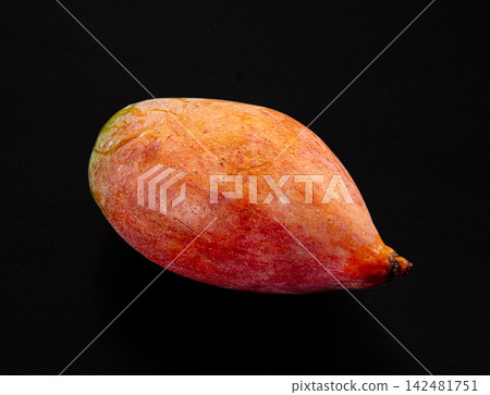 Ripe red and yellow mango fruit isolated on black background 142481751