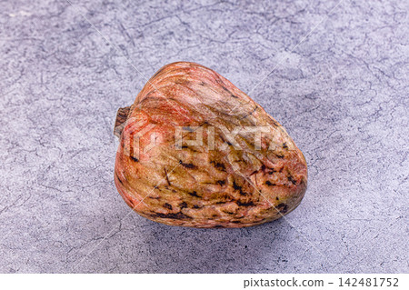 Exotic ripe annona cherimoya fruit on a gray textured stone background Exotic ripe annona cherimoya fruit on a gray textured stone background 142481752