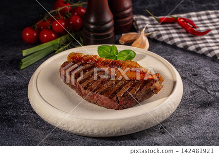 Grilled picanha steak with fresh basil on plate with vegetables Grilled picanha steak with fresh basil on plate with vegetables 142481921