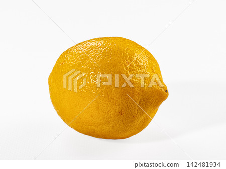 Whole yellow lemon with textured peel isolated on white background Whole yellow lemon with textured peel isolated on white background 142481934