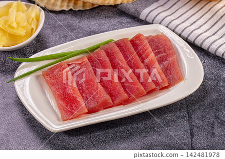 Raw tuna sashimi slices with ginger and green onion 142481978